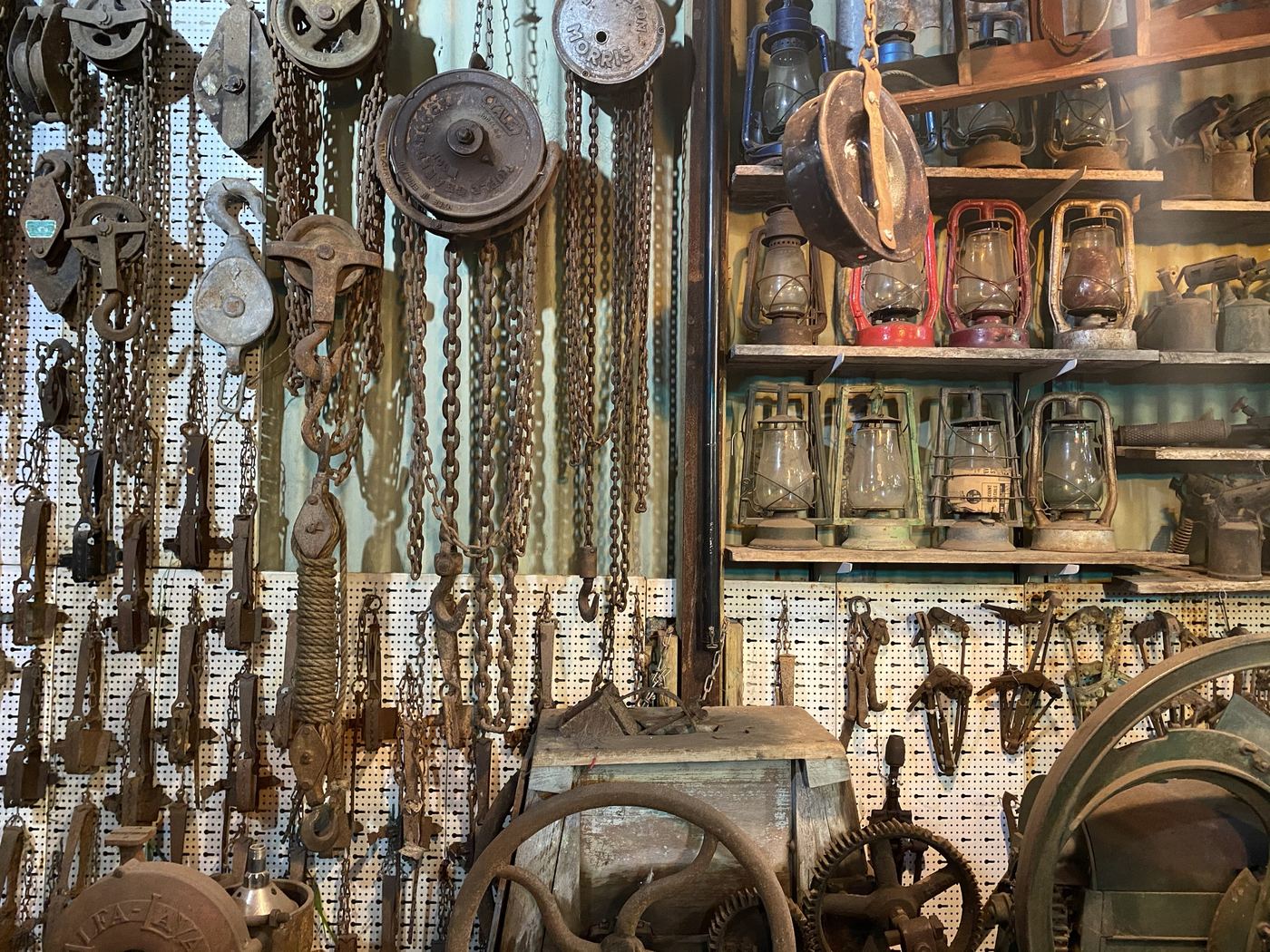 Chain blocks and pulleys beside shelves of kerosene lanterns